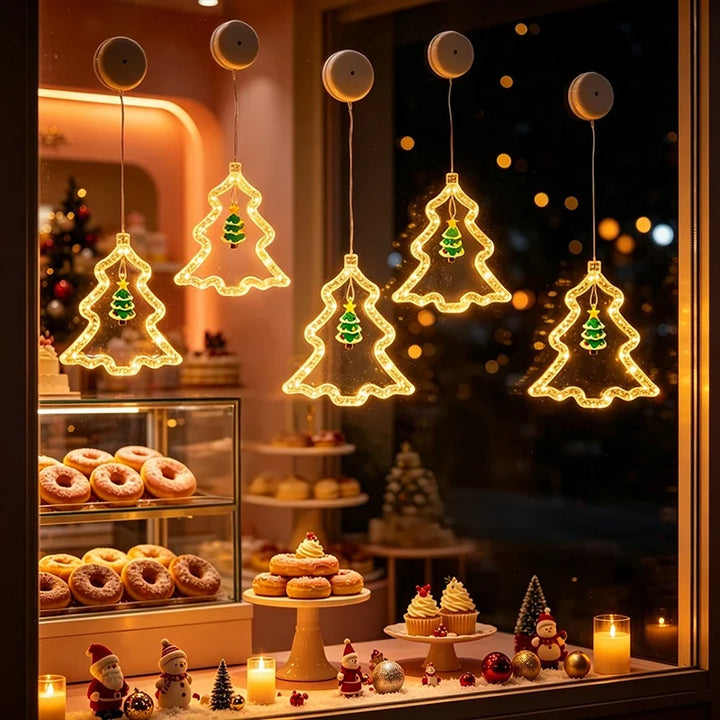árvores de natal com led na vitrine de confeitaria