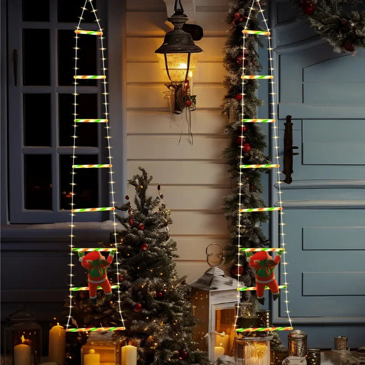 duas escadas de luz natalinas com papai noel ao lado da janela
