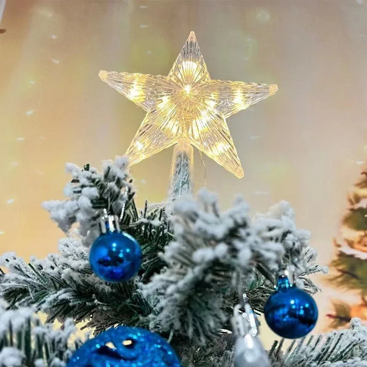 ponteira estrela iluminada em arvore de natal nevada