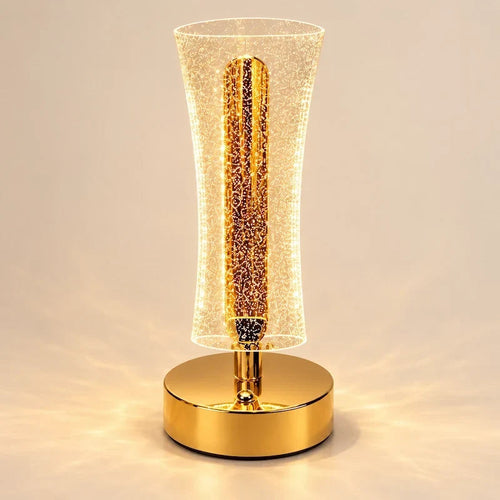 luminária de mesa led dourada com acabamento glitter acesa