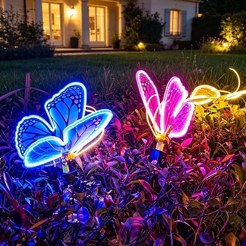borboleta led azul e rosa com asas em movimento no canteiro