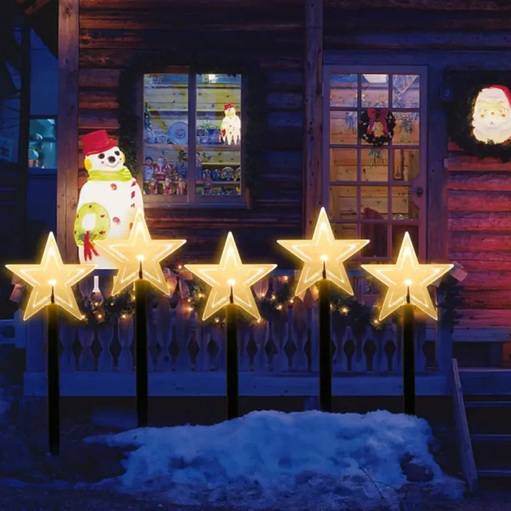 estacas solares de natal em formato de estrela iluminadas